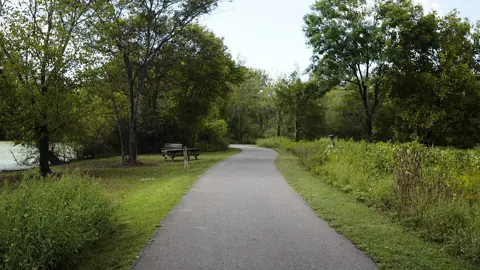 A paved path through the Shelby Bottoms Greenway in Nashville